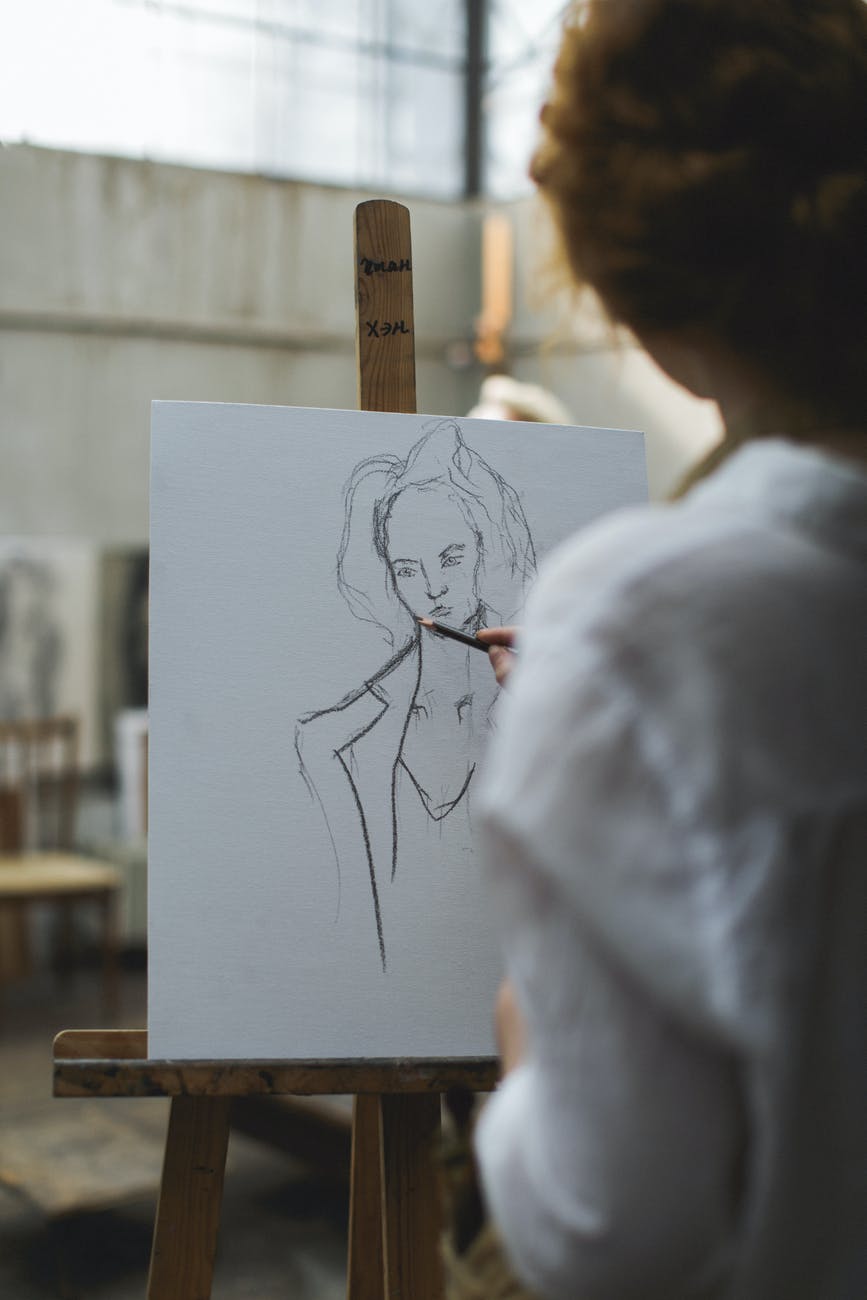 Woman sketching on an easel. 