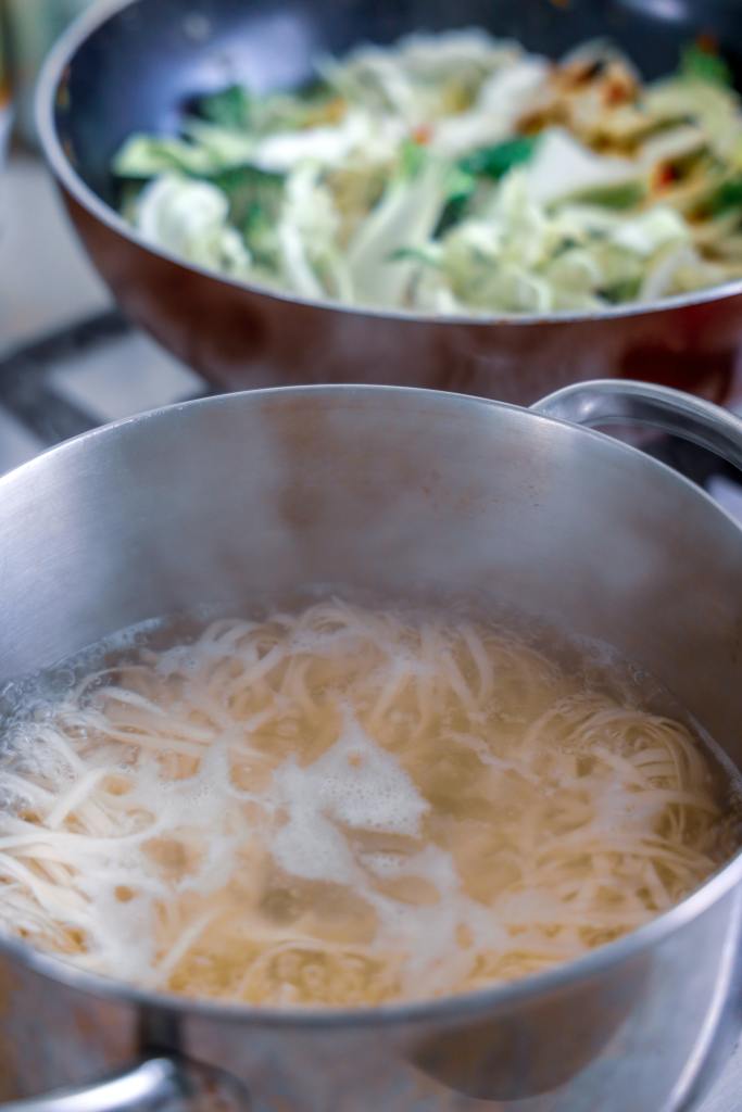 Pasta being boiled in a saucepan of water. 