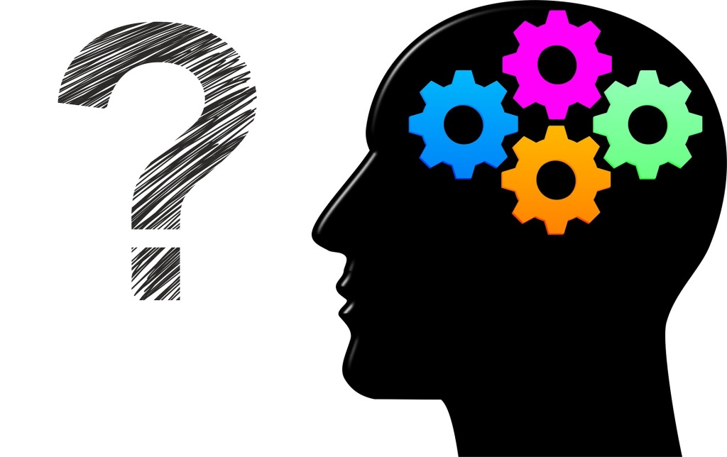 An Illustration of working memory. A black head with cogs inside to represent the brain, beside a question mark.
