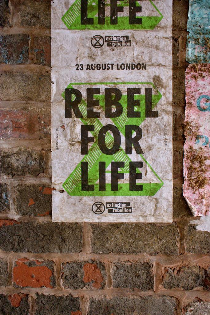 A poster on a break wall, reading "REBEL FOR LIFE"